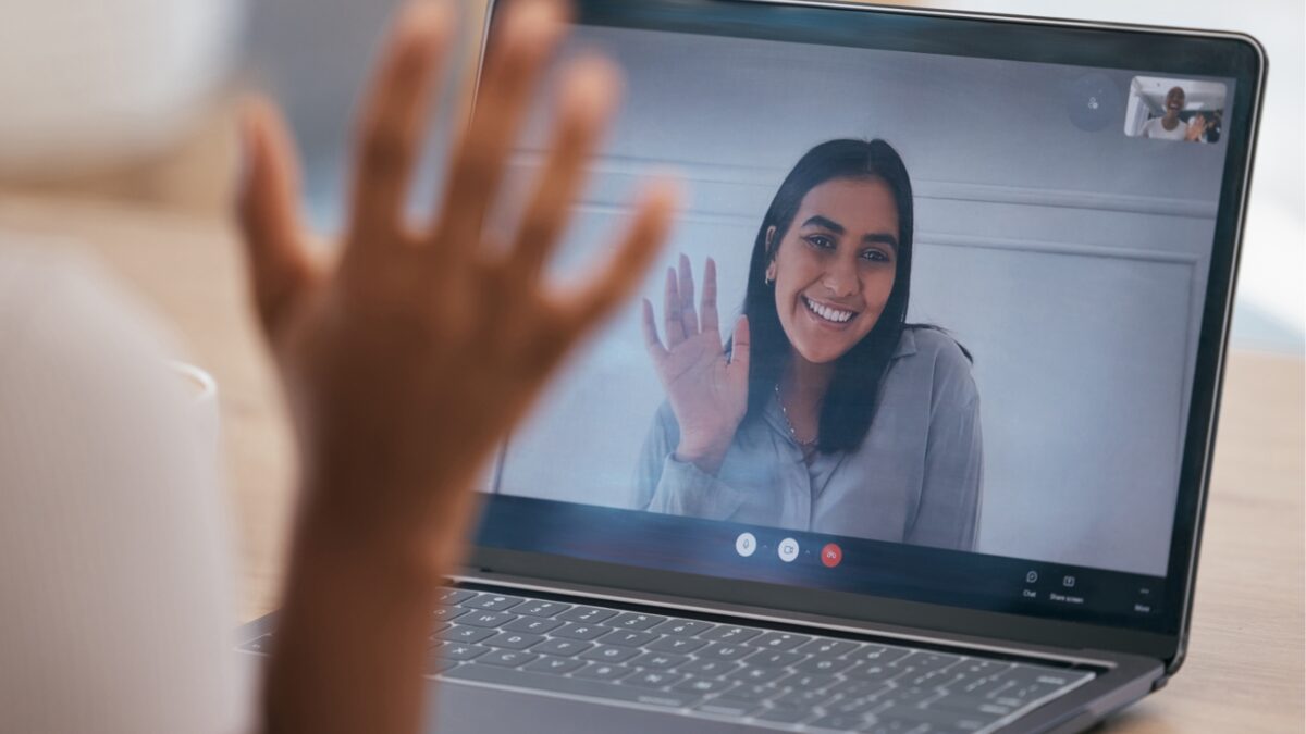 A learner waving to their coach at the start of a live video call